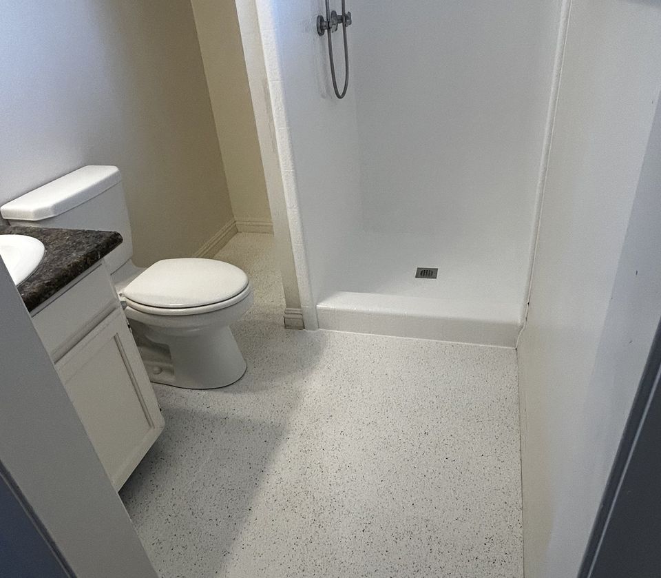 Refinished bathroom with textured shower surround