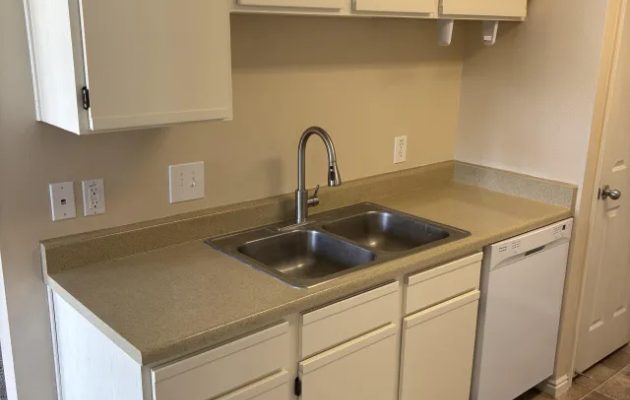 Galley kitchen cabinets refinished in clean uniform white