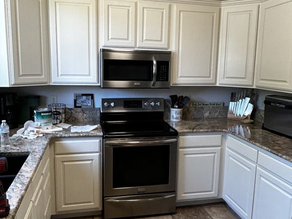 Same kitchen with freshly refinished white cabinets