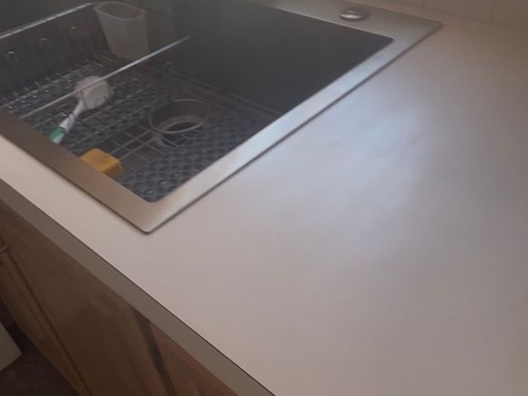 Flat white laminate kitchen countertop before resurfacing