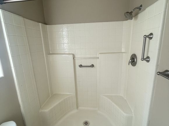 Yellowed fiberglass shower stall before refinishing