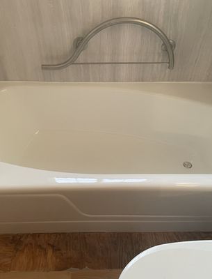 Refinished white bathtub with a glossy finish, completed by Young Again Refinishing