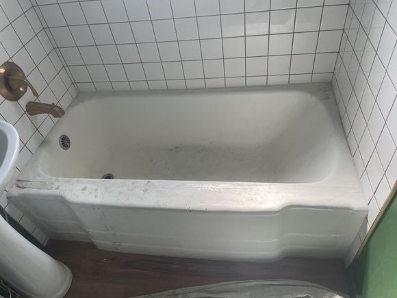 Worn bathtub before a custom color refinish