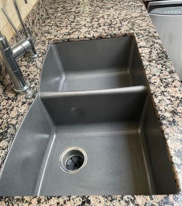 Refinished dark gray sink with granite countertop