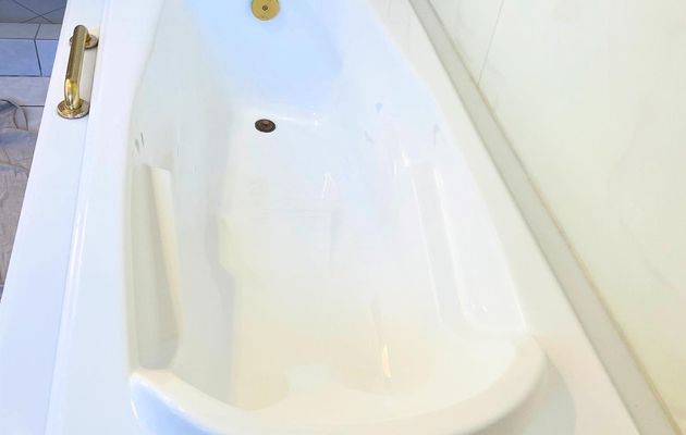 Drop-in bathtub refinished white with gold brass fixtures