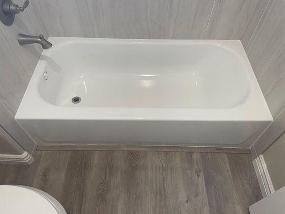 Bathtub with clean white glossy finish after refinishing