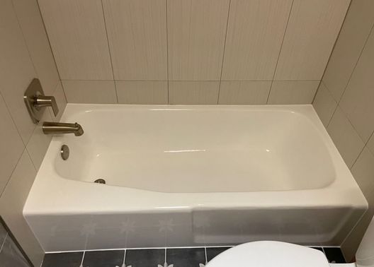 Refinished white bathtub with tile surround