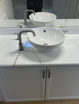 Bathroom vanity with faux marble veining and vessel sink