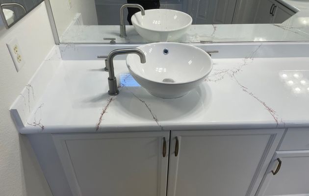 Bathroom vanity with faux marble veining and vessel sink