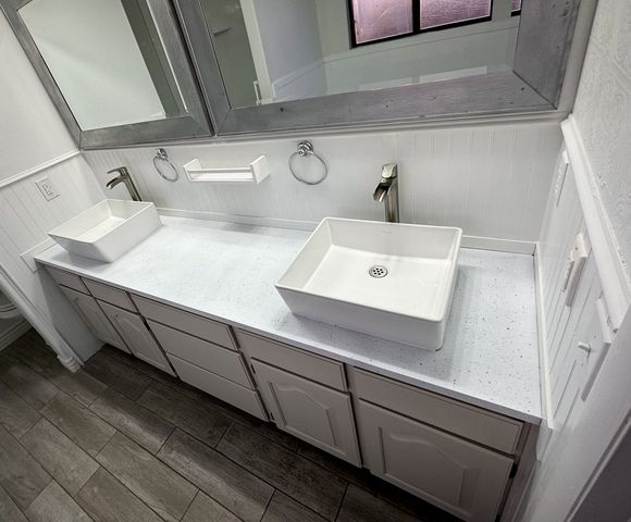 Refinished white speckled vanity countertop with dual vessel sinks in a St. George home