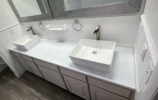 Bathroom vanity with refinished white speckle countertop and vessel sinks
