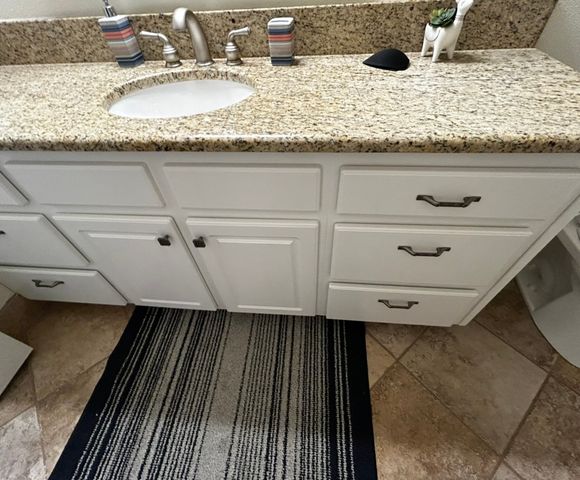 White bathroom sink refinished in a granite-look vanity top in a St. George home